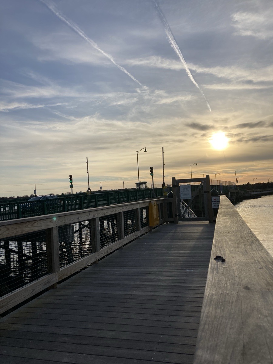 The Padanaram bridge boardwalk at sunset, looking across Apponagansett Bay